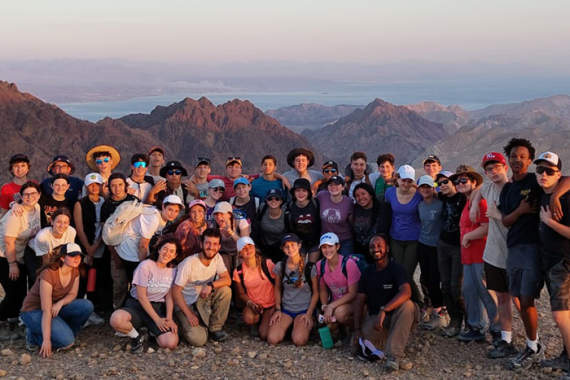 Yallah! Israel Participants posing in a group with majestic mountains behind them