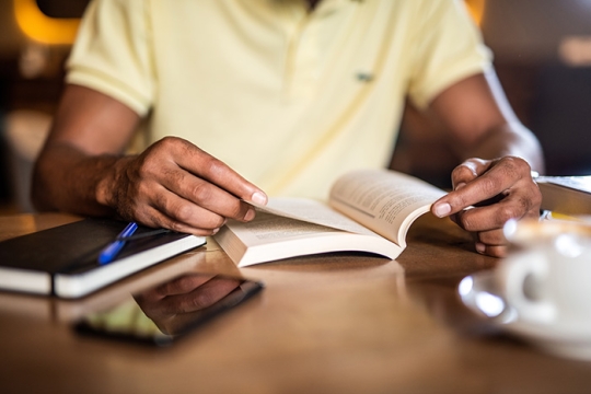 person studying books in a coffee shop