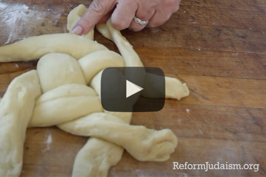 hands braiding challah